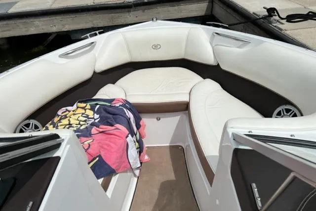 Slide: The Image of 2011 Cobalt 200 boat interior with white seating and colorful towel. - 4