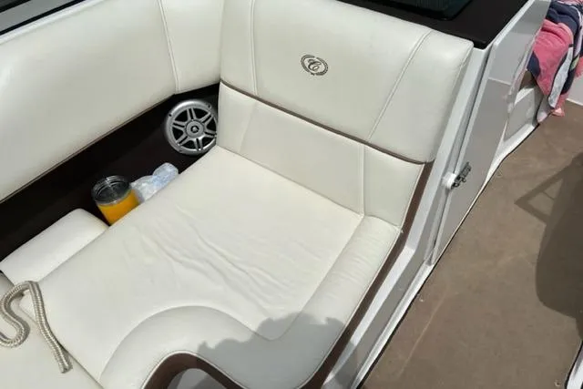 Slide: The Image of 2011 Cobalt 200 boat interior with white leather seating and speaker. - 5