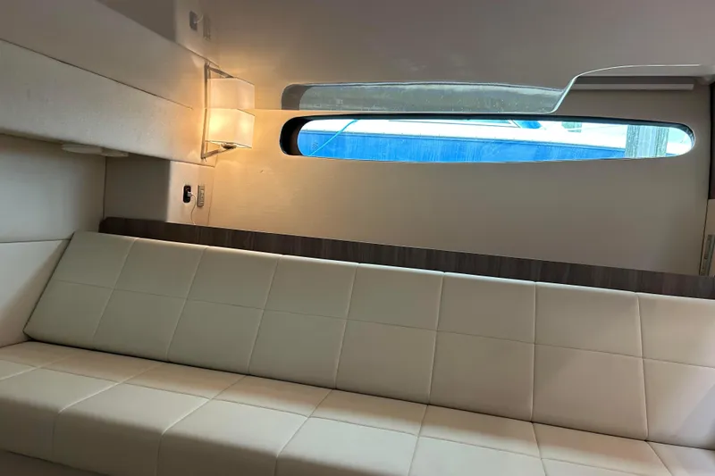 Slide: The Image of Interior of 2022 Regal 36 XO yacht with modern seating and window view. - 14