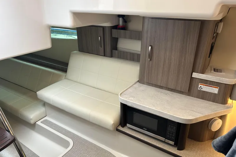 Slide: The Image of Interior of 2022 Regal 36 XO yacht with modern seating and kitchenette. - 15
