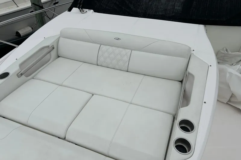 Slide: The Image of 2022 Regal 36 XO boat with luxurious white seating and cup holders. - 22