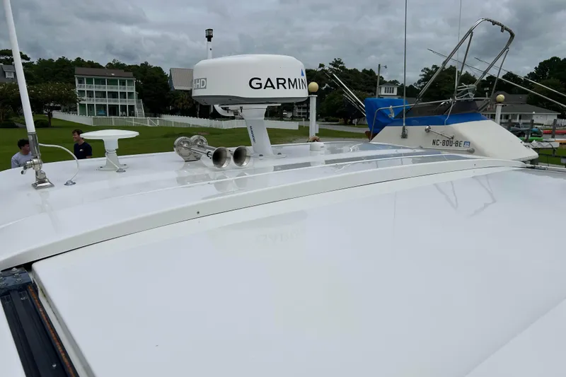 Slide: The Image of 2022 Regal 36 XO boat with Garmin radar, docked near residential area. - 23