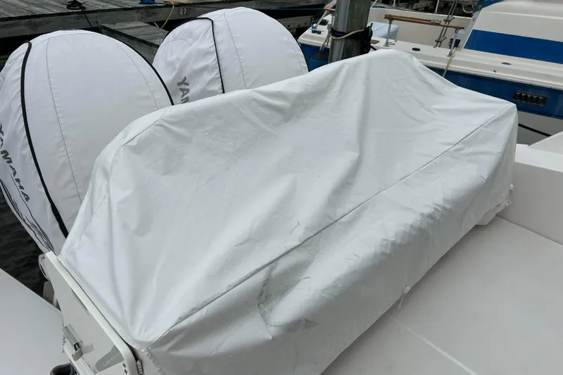 Slide: The Image of Covered outboard engines on a 2022 Regal 36 XO boat at a dock. - 5