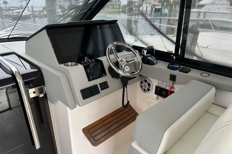 Slide: The Image of 2022 Regal 36 XO helm with modern controls and steering wheel. - 8