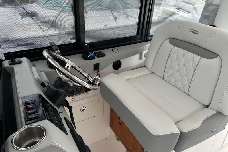 Slide: The Image of 2022 Regal 36 XO boat helm with luxurious seating and modern controls. - 9
