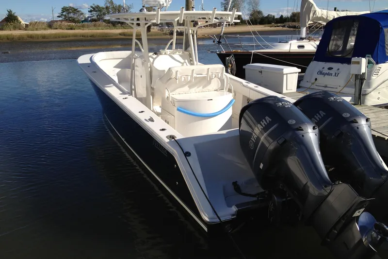 Slide: The Image of 2012 Jupiter 29 FS CC boat with twin Yamaha engines docked in calm waters. - 10