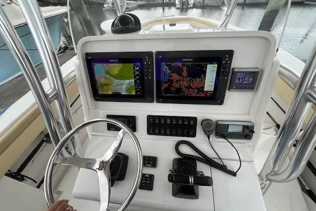 Slide: The Image of 2012 Jupiter 29 FS CC boat dashboard with navigation screens and controls. - 13