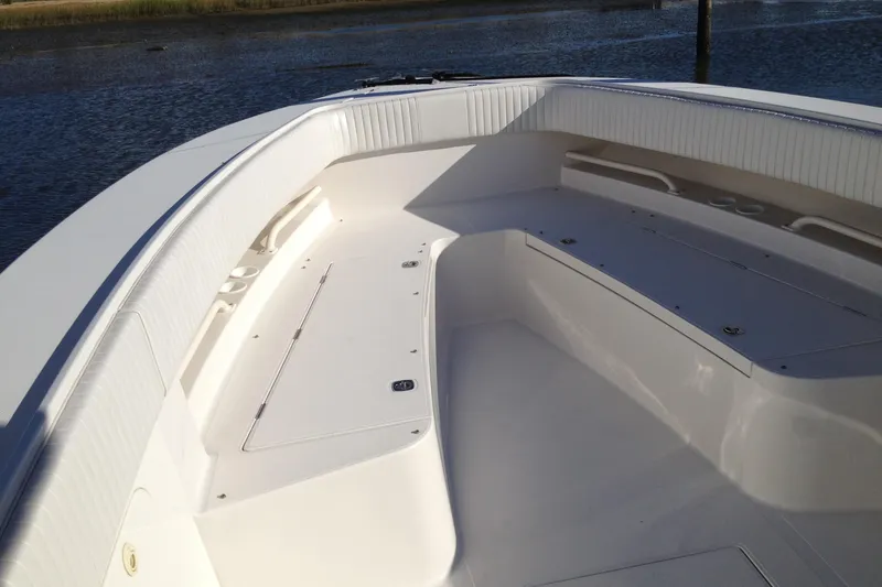 Slide: The Image of 2012 Jupiter 29 FS CC boat interior with spacious seating and storage, near calm water. - 15