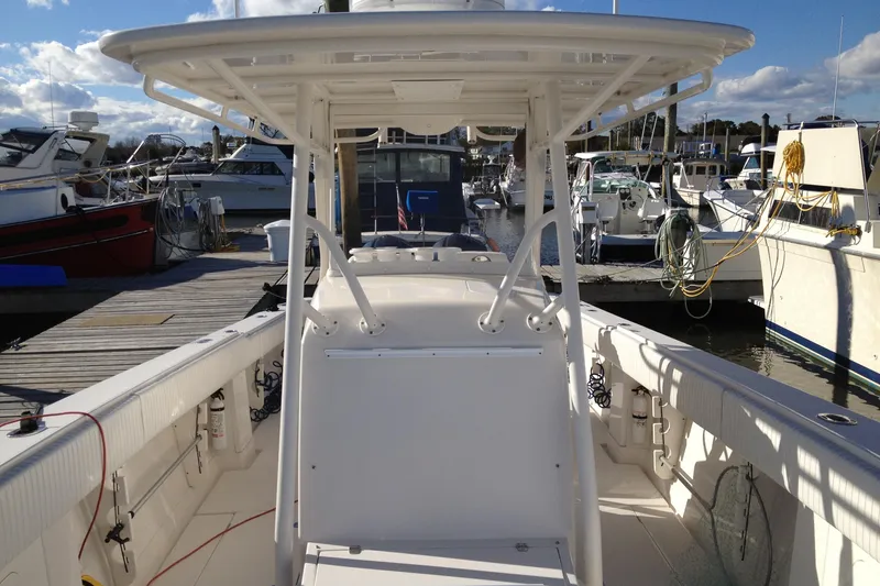 Slide: The Image of 2012 Jupiter 29 FS CC boat docked at marina, surrounded by other vessels. - 18