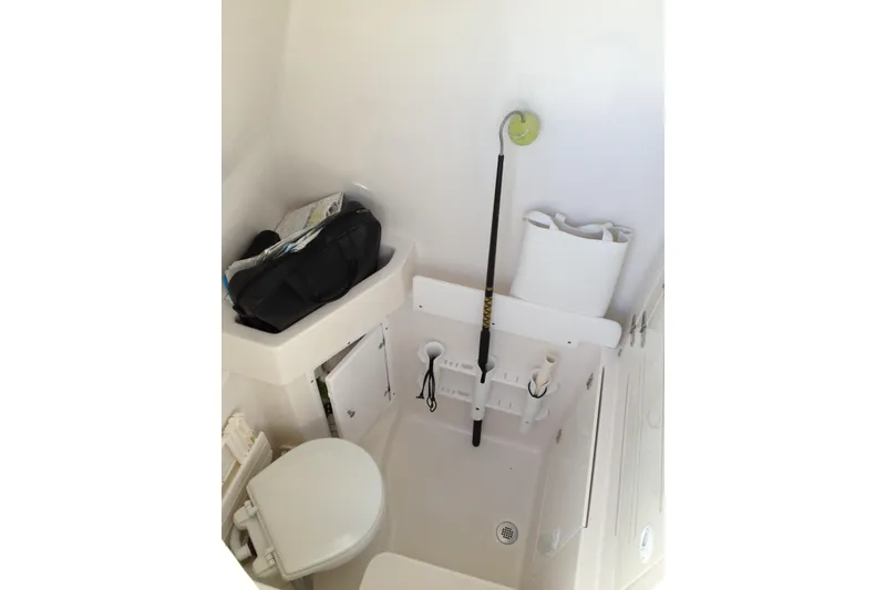 Slide: The Image of Interior of 2012 Jupiter 29 FS CC boat, featuring compact storage and toilet area. - 20