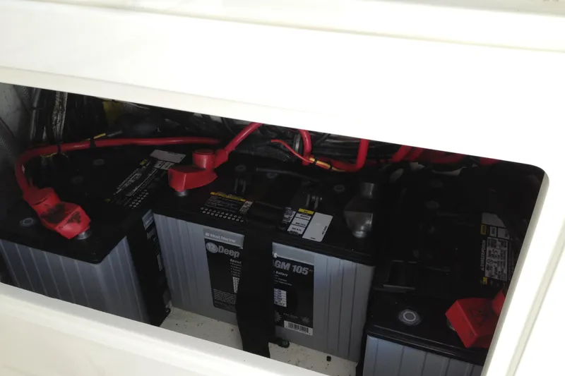 Slide: The Image of Battery compartment of 2012 Jupiter 29 FS CC boat with red cables and deep cycle batteries. - 21