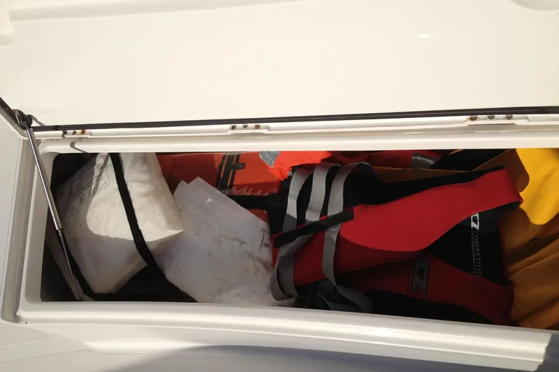 Slide: The Image of Storage compartment of 2012 Jupiter 29 FS CC boat with life jackets and gear. - 24