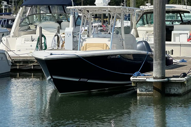 Slide: The Image of 2012 Jupiter 29 FS CC boat docked in marina, surrounded by other vessels. - 3