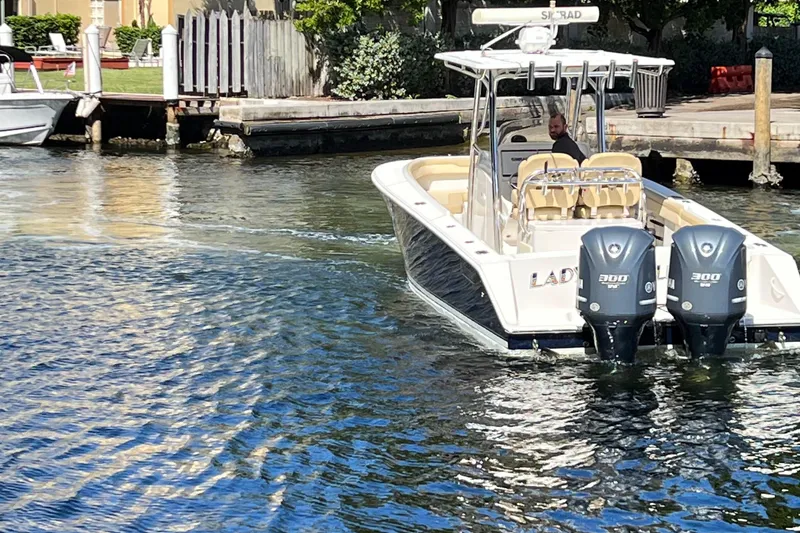 Slide: The Image of 2012 Jupiter 29 FS CC boat with dual engines cruising on a sunny waterway. - 4