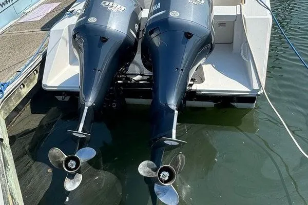 Slide: The Image of Twin outboard engines on a 2012 Jupiter 29 FS CC boat, docked in water. - 5