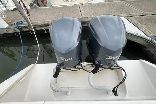Slide: The Image of Twin 300 horsepower outboard engines on a 2012 Jupiter 29 FS CC boat at dock. - 7