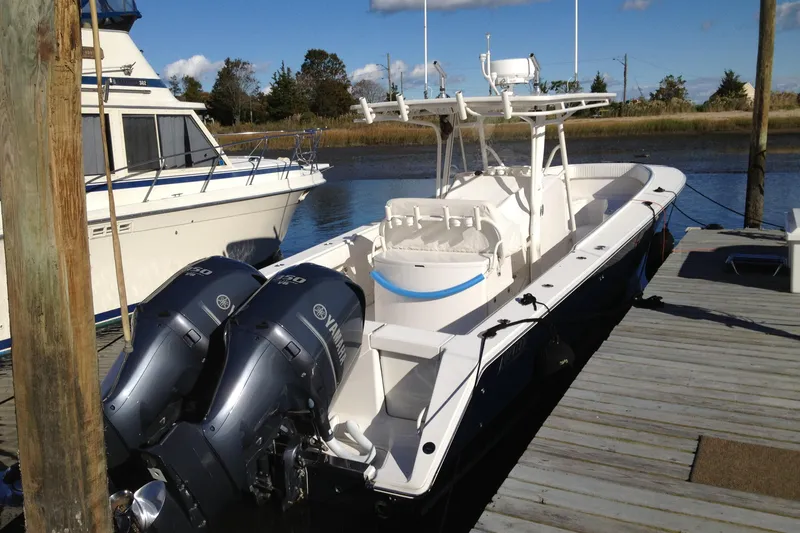 Slide: The Image of 2012 Jupiter 29 FS CC boat docked with twin Yamaha engines. - 9