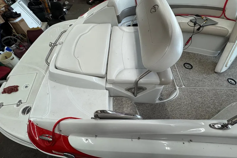 Slide: The Image of 2011 Crownline 252 EX boat interior with white seating and carpeted flooring. - 5