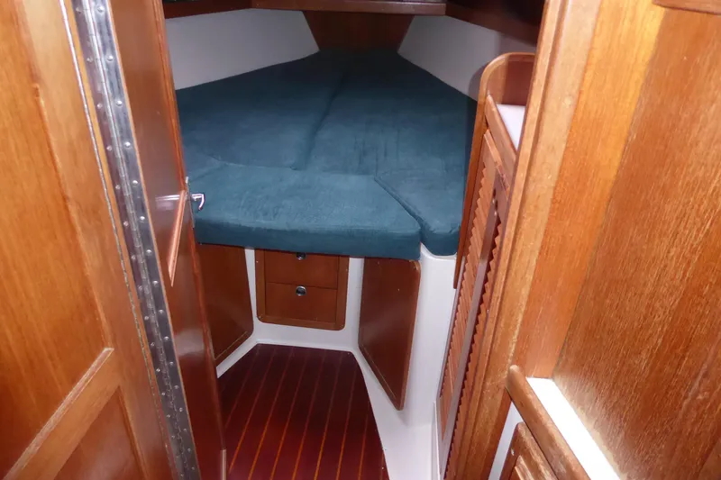 Slide: The Image of 1998 Catalina 36 MkII cabin interior with wooden finish and cozy sleeping area. - 11