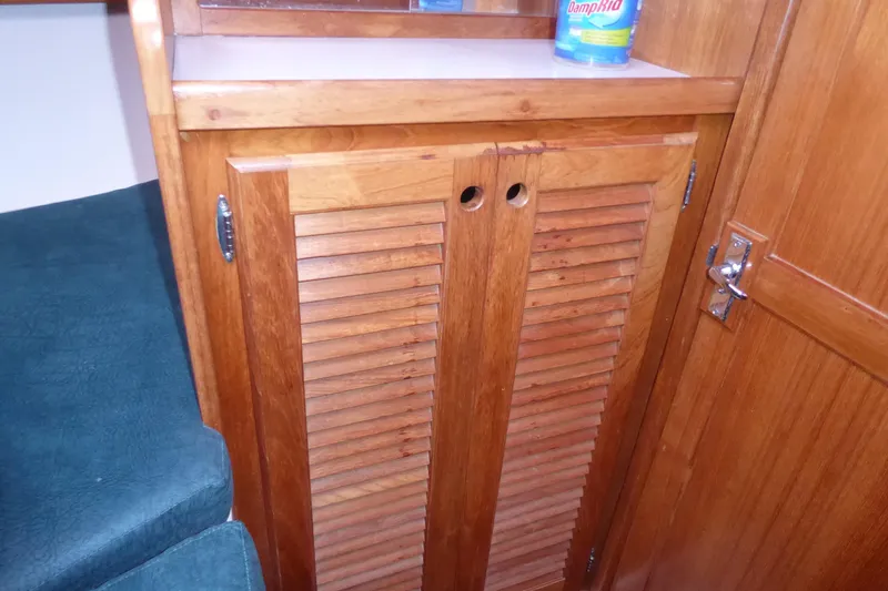 Slide: The Image of Wooden cabinet with louvered doors inside a 1998 Catalina 36 MkII sailboat. - 14