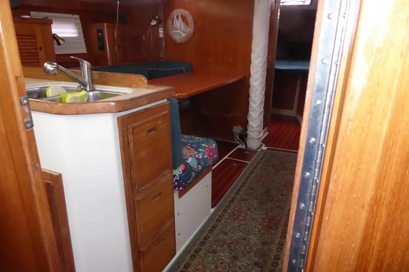 Slide: The Image of Interior of 1998 Catalina 36 MkII sailboat with wooden cabinetry and compact kitchen. - 15