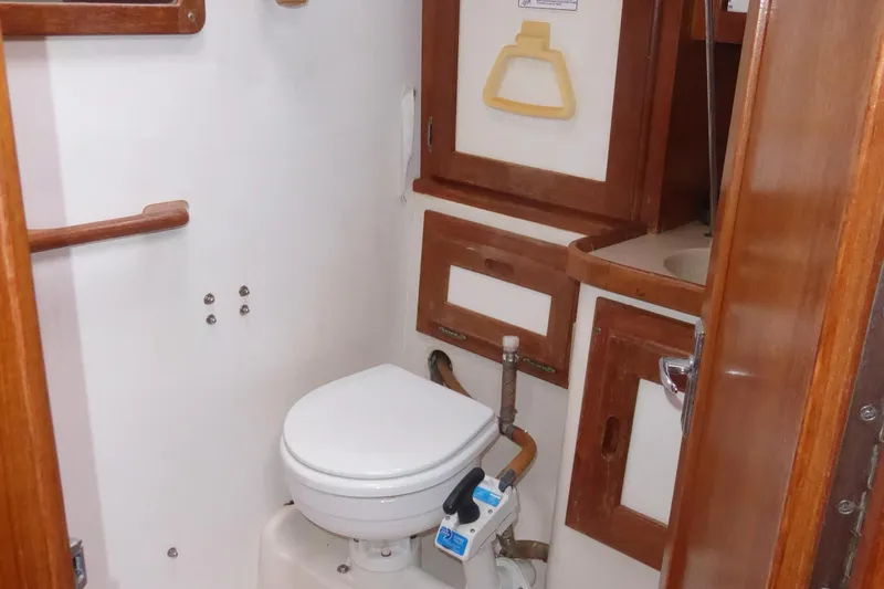 Slide: The Image of 1998 Catalina 36 MkII yacht bathroom with wooden cabinetry and compact toilet. - 17