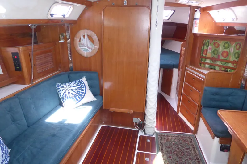 Slide: The Image of Interior of a 1998 Catalina 36 MkII sailboat with wood finish and blue seating. - 2