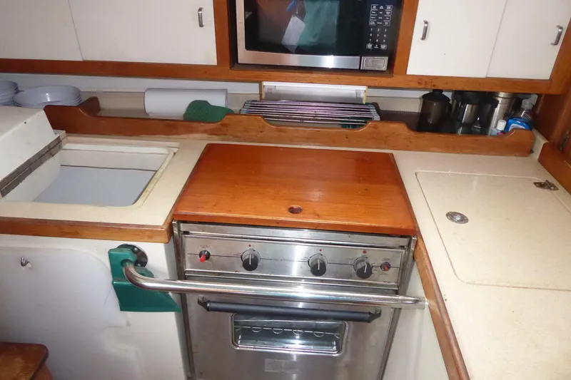 Slide: The Image of Compact kitchen in a 1998 Catalina 36 MkII sailboat with stove and microwave. - 20