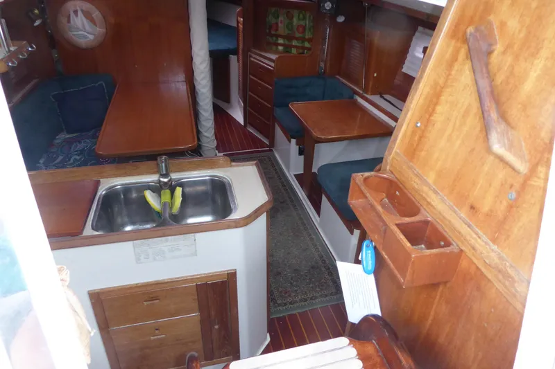 Slide: The Image of Interior of 1998 Catalina 36 MkII sailboat with wooden furnishings and compact kitchen area. - 27