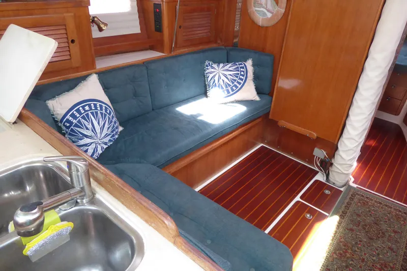Slide: The Image of Interior of 1998 Catalina 36 MkII sailboat with blue seating and wooden accents. - 3