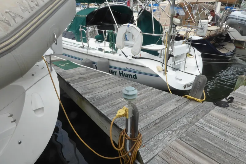 Slide: The Image of Catalina 36 MkII sailboat docked at marina, 1998 model, with visible deck and mooring lines. - 34