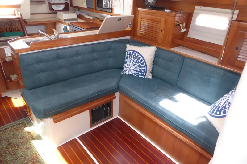 Slide: The Image of Interior of 1998 Catalina 36 MkII sailboat with blue cushioned seating and nautical decor. - 4
