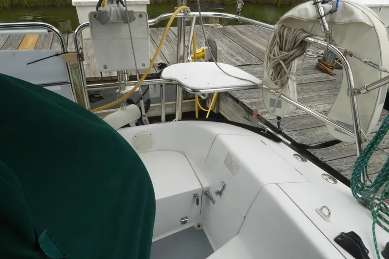Slide: The Image of Cockpit of a 1998 Catalina 36 MkII sailboat docked, featuring seating and nautical equipment. - 42