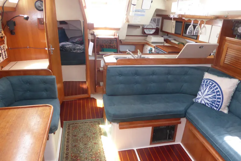 Slide: The Image of Interior of 1998 Catalina 36 MkII sailboat with cozy seating and wooden finishes. - 5