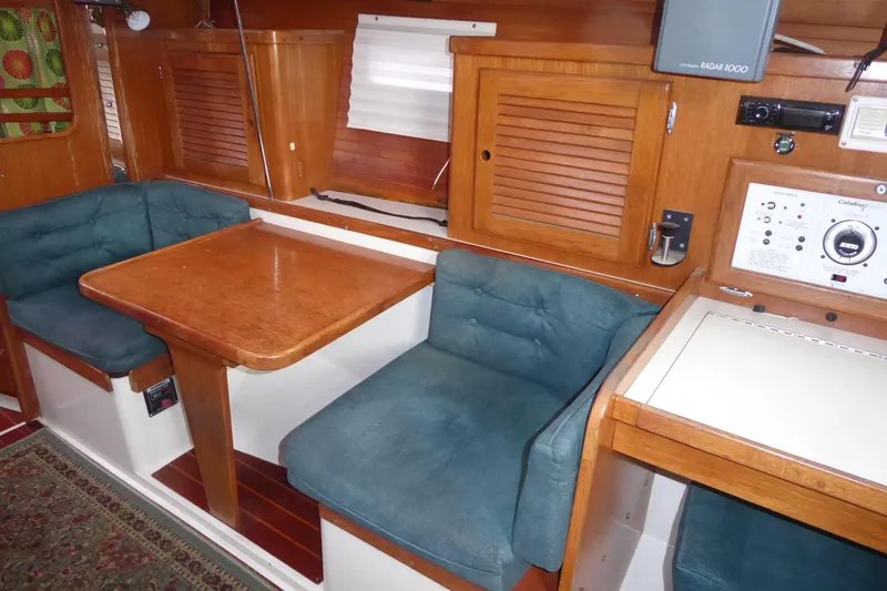 Slide: The Image of Interior of 1998 Catalina 36 MkII sailboat with wooden table and blue cushioned seating. - 8