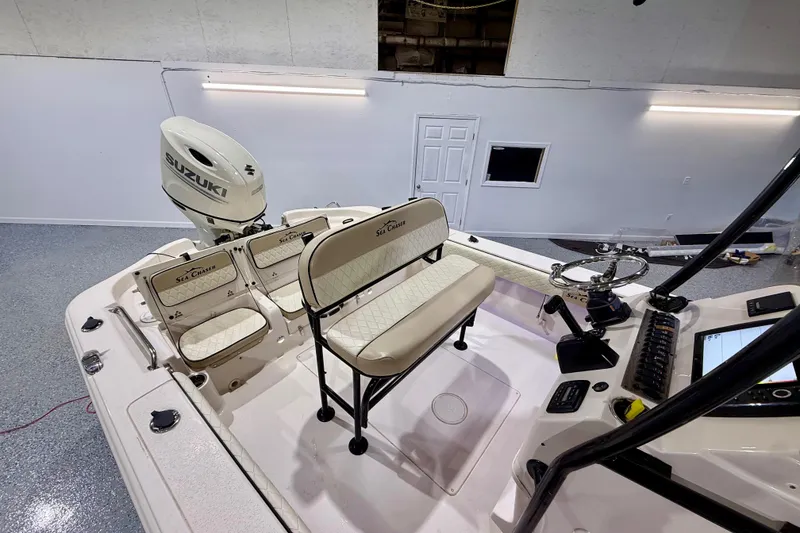 Slide: The Image of 2020 Sea Chaser 23 LX boat interior with Suzuki engine, featuring seating and control panel. - 17