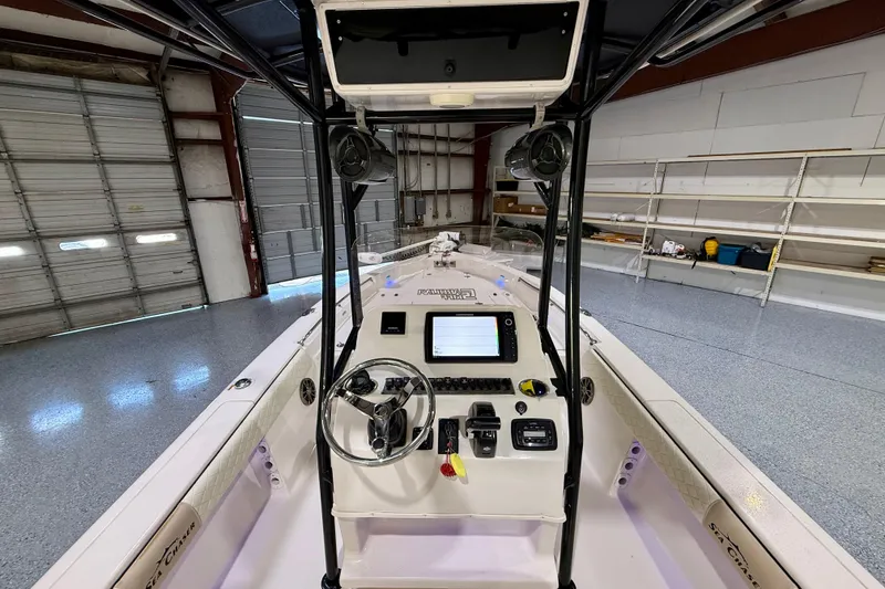 Slide: The Image of 2020 Sea Chaser 23 LX boat interior with steering console in a garage setting. - 21