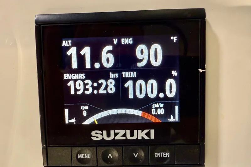 Slide: The Image of Suzuki engine display showing 11.6 volts, 90°F, 193.28 hours on Sea Chaser 23 LX. - 25
