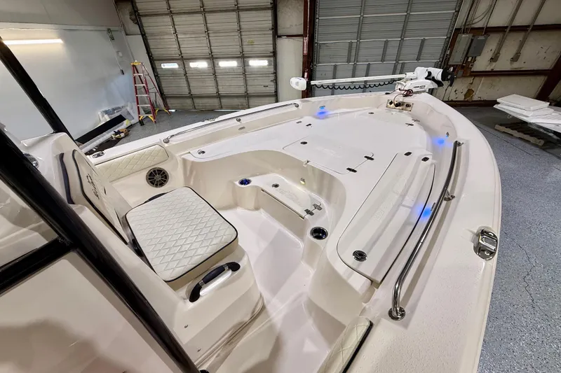 Slide: The Image of 2020 Sea Chaser 23 LX boat interior with seating and storage in a garage setting. - 26