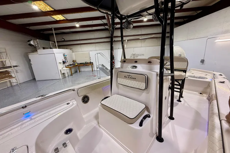 Slide: The Image of 2020 Sea Chaser 23 LX boat interior in a spacious garage setting. - 29