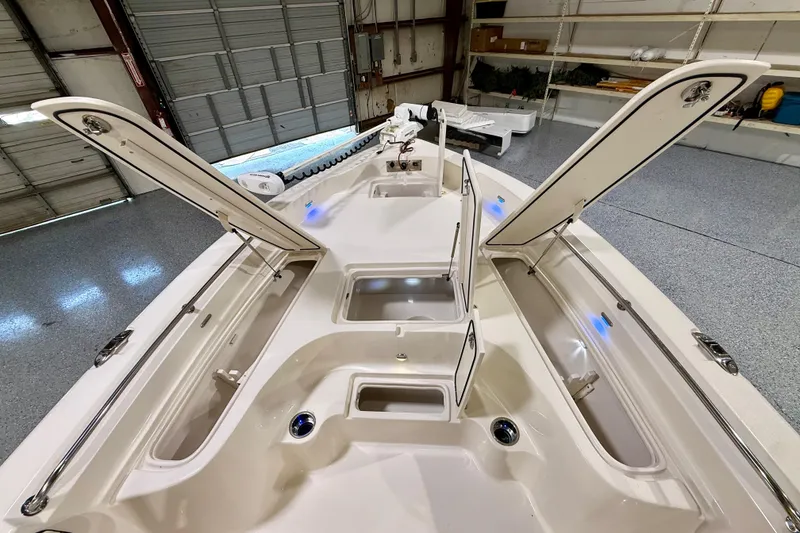 Slide: The Image of 2020 Sea Chaser 23 LX boat interior with open storage compartments in a garage setting. - 31