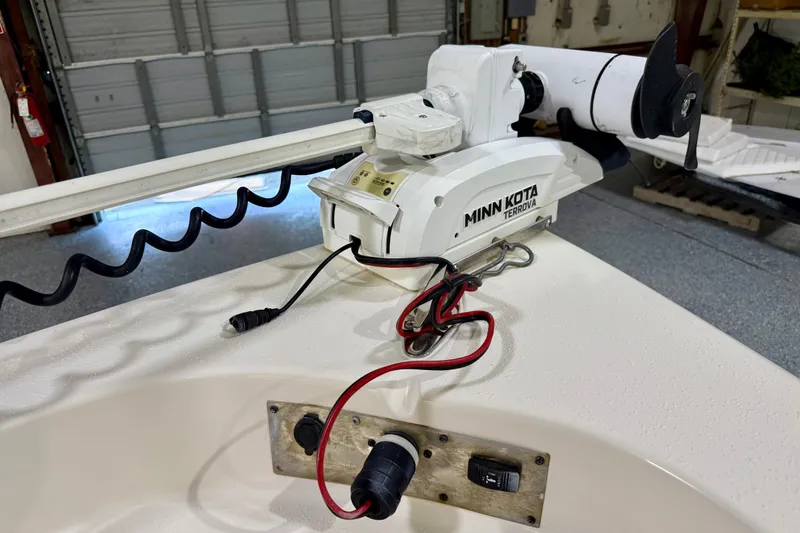Slide: The Image of 2020 Sea Chaser 23 LX with Minn Kota Terrova trolling motor in a garage setting. - 32