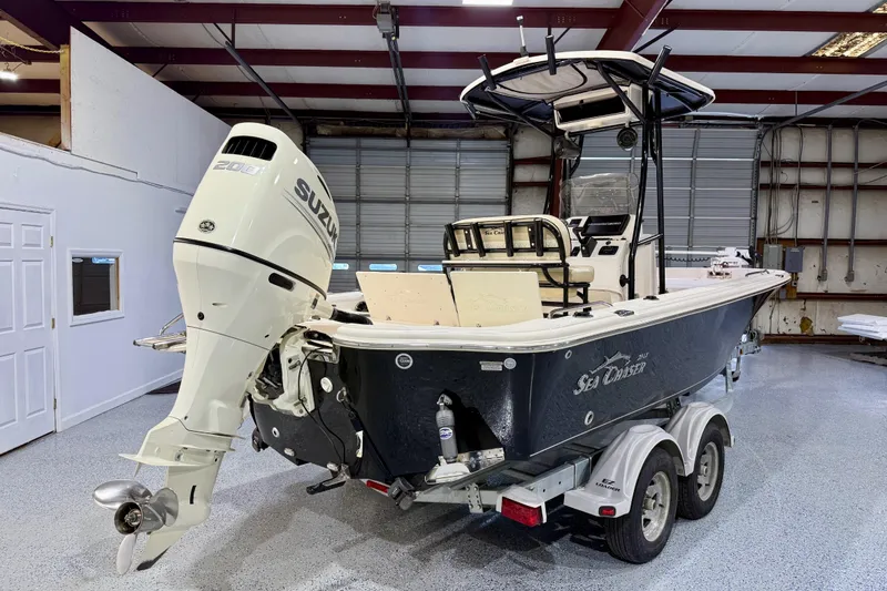 Slide: The Image of 2020 Sea Chaser 23 LX boat with Suzuki engine in a garage setting. - 4