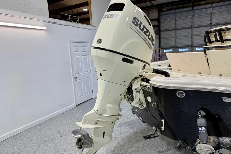 Slide: The Image of 2020 Sea Chaser 23 LX boat with Suzuki 200 outboard motor in a garage setting. - 5