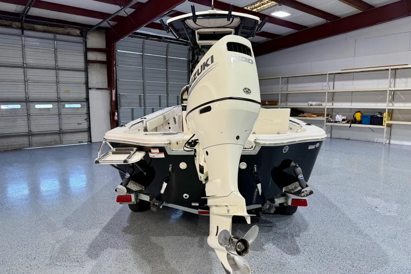 Slide: The Image of 2020 Sea Chaser 23 LX boat with Suzuki engine in a spacious garage. - 6