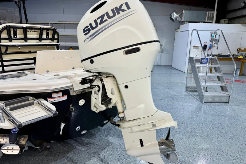 Slide: The Image of 2020 Sea Chaser 23 LX boat with Suzuki outboard motor in a garage setting. - 7