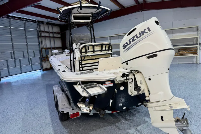 Slide: The Image of 2020 Sea Chaser 23 LX boat with Suzuki outboard motor in a garage. - 8
