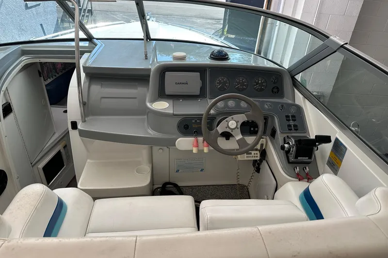 Slide: The Image of 1997 Formula 330 Sun Sport boat cockpit with steering wheel and navigation equipment. - 3