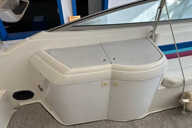 Slide: The Image of 1997 Formula 330 Sun Sport boat interior with storage compartment and seating area. - 4