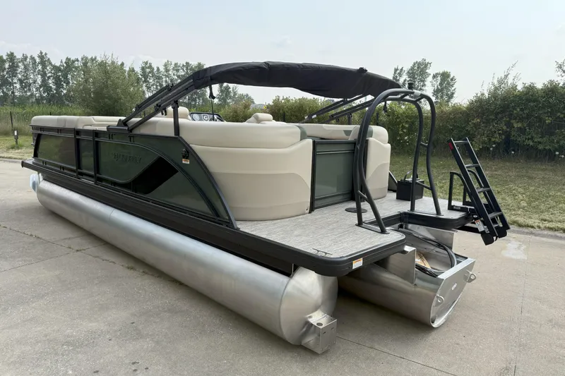Slide: The Image of 2026 Godfrey SW 2286 SB pontoon boat with beige seating and black canopy. - 2